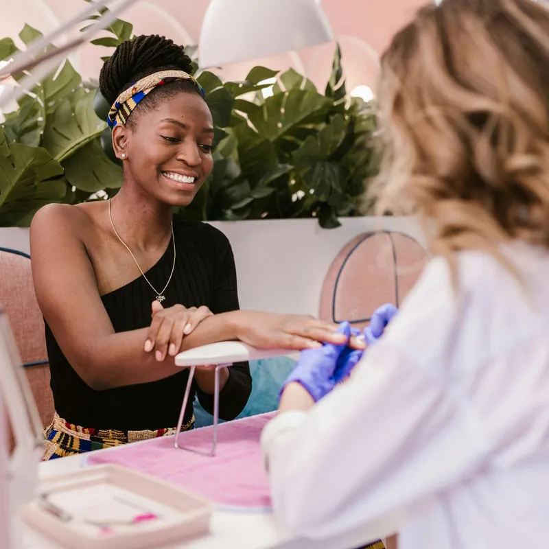 Beauty professional with client